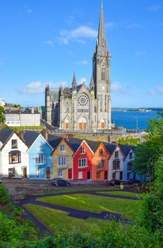 colorful houses in front of a large cathedral