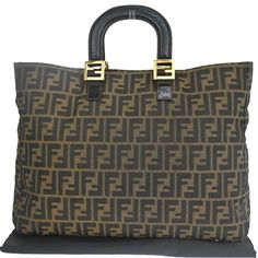 Authentic Fendi Zucca Tote Bag Material: Canvas/Leather Color: Brown Comes With: Dust Bag Country Of Manufacture: Italy Measurements: Width: 16.1” Height: 12.2” Depth: 5.9” Handle Drop: 3.5” Fendi Bags, Canvas Leather, Womens Tote Bags, Chanel Bag, Black And Brown, Fendi, Dust Bag, Chanel, Tote Bag