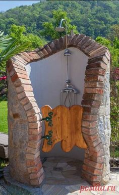 an outdoor shower in the middle of a garden