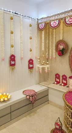 a decorated room with pink and gold decorations on the wall, white walls and floor