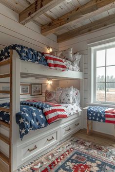 two bunk beds with american flags on them in a room that has white walls and wood beams