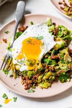 an egg is sitting on top of a bed of brussel sprouts