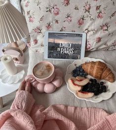 a table topped with plates of food next to a cup of coffee and an ipad