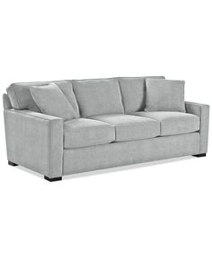 a gray couch sitting on top of a white floor