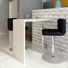 a white counter top sitting next to a black chair in front of a brick wall