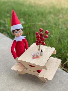 an elf sitting at a picnic table with berries on it