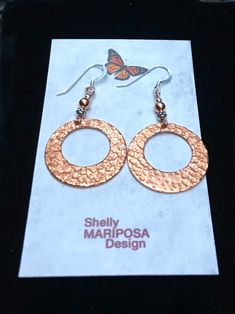 Lightweight Hammered copper hoop dangle earrings. Looking for something lightweight, bright and natural? This simple yet elegant pair of hammered copper earrings will definitely catch the light! These earrings are solid high-quality copper. One side is hammered, the other side of smooth. These earrings are 1 inch in diameter. They are very light weight, only 2 g. French ear wires are also solid copper. All my jewelry comes gift boxed with a custom Shelly Mariposa Design butterfly card ready for Hammered Copper Drop Earrings, Hammered Copper Earrings For Gift, Hammered Copper Hoop Earrings As Gift, Copper Hammered Hoop Earrings As Gift, Hammered Copper Round Hoop Earrings, Hammered Rose Gold Copper Earrings, Hammered Rose Gold Copper Jewelry, Rose Gold Hammered Dangle Earrings, Handmade Copper Round Hoop Earrings