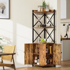 a wooden cabinet with wine glasses and bottles on it next to a dining room table