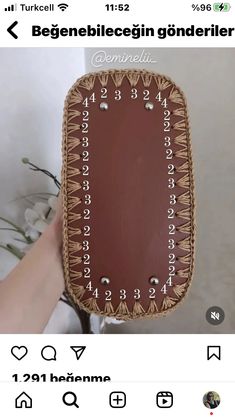 someone is holding up a wooden clock with numbers on it