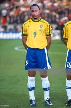 two soccer players standing on the field in front of an audience at a sporting event