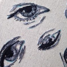 an eye is drawn on the fabric with black and white ink, while other drawings are drawn