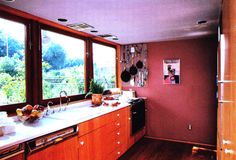 the kitchen is clean and ready to be used for cooking or baking, with lots of natural light coming in from the windows