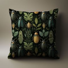 a green and yellow pillow with bugs on it's back, surrounded by leaves