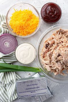 ingredients to make chicken salad laid out in bowls