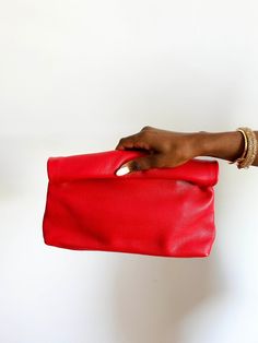 This is a gorgeous made to order high quality leather clutch bag. The bag is made of beautiful soft high quality leather. Big enough to fit your phone, sunglasses, wallet and any other essentials without being too bulky. Each bag is made to order and comes with a dust bag. This item will be shipped directly from it's maker to you. The key to sustainability is buying pieces you love, caring for them and wearing them forever. This will be one of those items for you. 100% Genuine Leather. Dimension Red Clutch Pouch For Evening, Red Clutch Evening Bag With Removable Pouch, Chic Red Rectangular Pouch, Everyday Leather Clutch With Fold Over Clasp, Red Travel Clutch Pouch, Pouch Evening Bag With Fold Over Clasp, Red Clutch With Removable Pouch, Red Shoulder Bag Clutch For Daily Use, Soft Leather Clutch Evening Bag