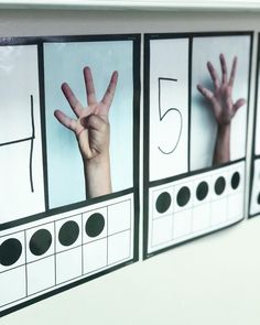 three pictures with hands and numbers on them hanging on the wall in front of a mirror