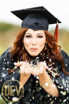 a woman wearing a graduation cap and gown throwing confetti in the air with her hands