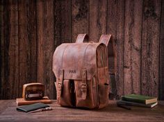 Personalized Daily Backpack, Handmade Full Grain Leather Backpack, Travel Backpack, Laptop Backpack, Men Leather Rucksack, Best Men Gift Personalization We can engrave any picture, initials, name, or logo etc on any location.  Please send picture with Etsy message and leave a note at checkout with what you would like personalized on. Features: 1. Heavy full Grain Leather, about 2.3kg in weight 2. Cotton inside lining,Brass hardware, Magnetic buttons 3. Inside zipper pocket, laptop sleeve,cell po Everyday Carry Backpack With Adjustable Strap, Waxed Finish Satchel Backpack For School, Leather Backpack With Adjustable Strap For Back To School, Leather Bag For Outdoor And Back To School, Back To School Leather Outdoor Bag, Leather Bags For Back To School Outdoor Use, Backpack Handmade, Daily Backpack, Everyday Backpack