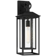 an outdoor wall light that is black and has a clear glass panel on the front