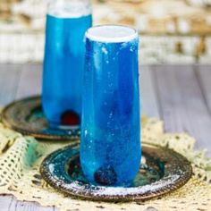 two blue drinks sitting on top of a table