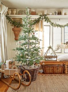 a living room with a christmas tree in the corner and other decorations on the wall