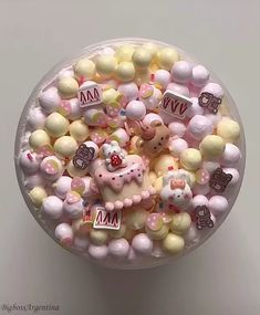 a bowl filled with hello kitty candies on top of a table