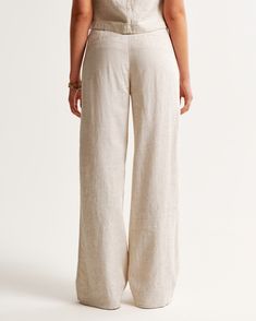 Our signature A&F Sloane Tailored Pant in our soft linen-blend fabric, that's perfect for dressing up or down. The Sloane Tailored Pant is an ultra-high rise tailored wide leg pant with figure-flattering pleating details, a functional fly and pockets and a partially elasticated waistband for ultimate adjustability. The intended length hits the bottom of a flat shoe. Please reference our size chart to determine your perfect size and inseam! Chic Relaxed Fit Flax Bottoms, Full Length Linen Bottoms For Loungewear, Relaxed Straight Leg Bottoms In Neutral Color, Non-stretch Linen Pants For Loungewear, Summer Relaxed Mid-rise Pants, Versatile Beige Linen Bottoms, Relaxed Fit Full Length Linen Bottoms, Versatile Beige Linen Pants, Relaxed Fit Full-length Linen Bottoms