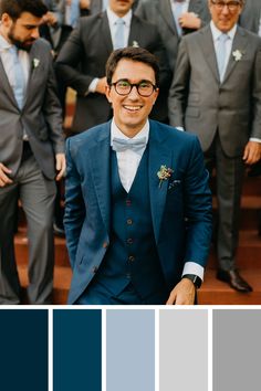 a group of men in suits and ties standing next to each other with different colors