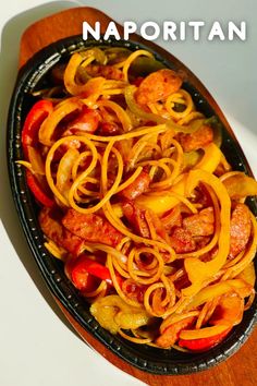 a pan filled with pasta and meat on top of a white countertop next to a knife