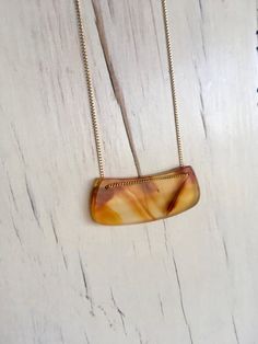 A stunning slightly curved carnelian slab hangs on a gold filled chain to create a one of a kind statement necklace.Length 20 inchesPendant size is 1 3/4 inch by a little over a half inch.MATERIAL:GOLD-FILLED - 14k Gold filled is considerably durable and considered a lifetime piece of jewelry. This is NOT gold plated or gold dipped vermeil jewelry which can chip off over time with wear. Gold filled metal is essentially a 14k gold tube filled with an inner core metal such as brass and has been me Necklace Formal, Pearl Bar Necklace, Chrysoprase Necklace, Fluorite Necklace, Gemstone Choker, Curved Bar, Carnelian Necklace, Aquamarine Pendant, Moissanite Necklace