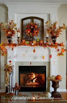 a fireplace decorated with fall leaves and pumpkins