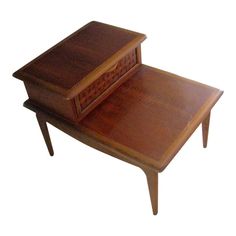 a small wooden table with a drawer on it's top and one drawer open