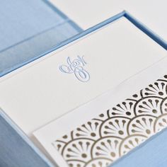 the inside of a blue and white wedding card with an intricate laser cut design on it