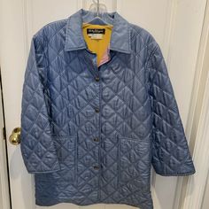 This is a VINTAGE Salvatore Ferragamo quilted silk jacket. The color is a light blue and it has a beautiful abstract print inside lining which is also 100% silk. Two large pockets in front and vents in the back at the bottom of the coat (with snap button closures). The silver metal buttons all say 'Ferragamo'.  The buttons are snap buttons.  The coat looks to be in very good condition--no tears or snags.  It can be worn with the sleeves folded up, or not.  It is probably a 3/4 length sleeve for Blue Winter Outerwear For Daywear, Vintage Long Sleeve Outerwear For Daywear, Blue Long Sleeve Outerwear For Daywear, Vintage Blue Outerwear For Fall, Blue Vintage Outerwear For Fall, Vintage Blue Long Sleeve Blazer, Vintage Quilted Outerwear For Spring, Vintage Quilted Outerwear For Fall, Casual Blue Outerwear For Daywear