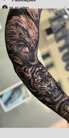 an arm with a tiger and eagle tattoo on it