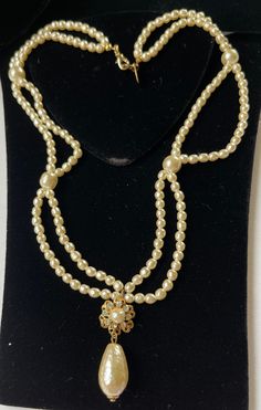 "Here is a very pretty vintage necklace by designer Miriam Haskell. The necklace is beautifully crafted with double strands of petite sized lustrous faux baroque pearls. The glistening pearl strands are linked at four stations with larger sized faux baroque pearls. The necklace drops down to a creamy faux pearl drop pendant that is accented with a gilt filigree faux pearl and clear rhinestone flower on top. The hardware is in gold tone metal and the necklace closes with a lobster clasp. This nec Pearl Drop Pendant, Miriam Haskell, Rhinestone Flower, Pearl Strands, Lovely Jewellery, Drop Pendant, Pearl Drop, Baroque Pearls, Clear Rhinestones