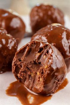 chocolate covered doughnuts sitting on top of a table