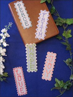 cross stitch bookmarks on blue cloth with flowers