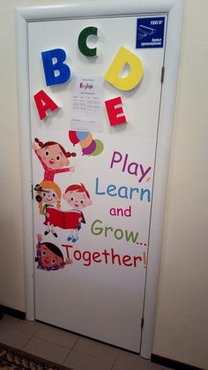 a door decorated with children's letters and magnets to help them learn how to read