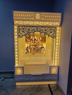 an illuminated shrine with the image of jesus and mary in gold, blue and white