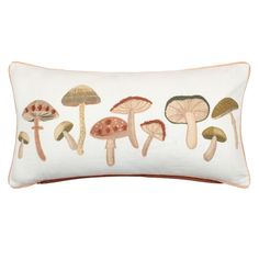 an embroidered pillow with mushrooms on it