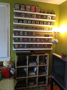 a living room filled with furniture and a flat screen tv sitting on top of a wooden shelf