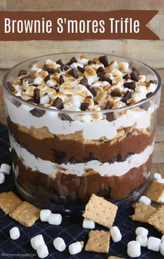 brownie s'mores trifle in a glass dish with marshmallows