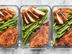 three plastic containers filled with chicken, green beans and potatoes on top of a marble counter