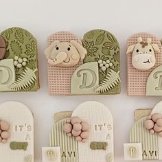 four decorated cookies with animals and letters on them