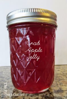 a jar filled with red liquid sitting on top of a counter