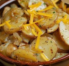 a bowl filled with potatoes covered in cheese