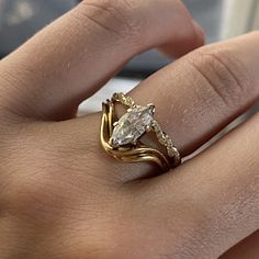 a woman's hand with a ring on it and a diamond in the middle