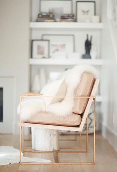 a living room filled with furniture and a fire place next to a white book shelf