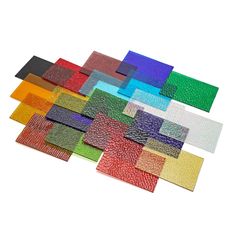 many different colors of glass on a white background